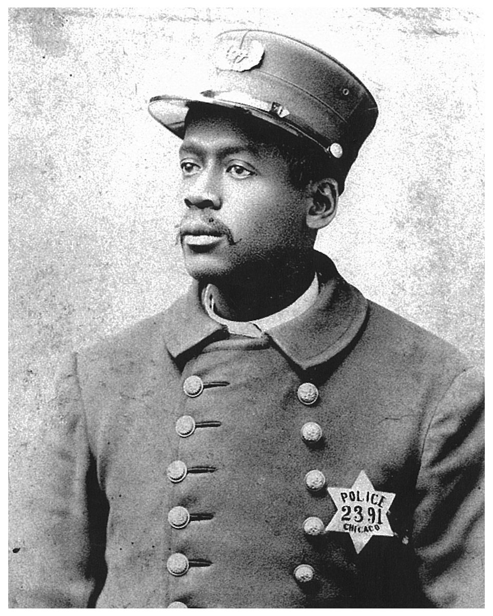 Photograph of Jame L. Shelton wearing a peaked cap and a double-breasted overcoat with an attached police badge.