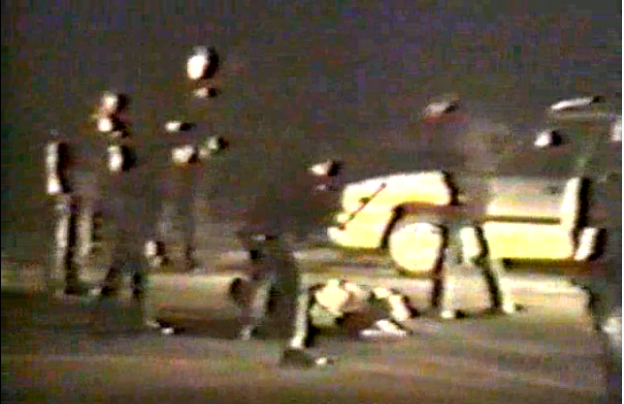 Freeze frame showing Rodney King’s ruthless assault by a group of police officers captured on videotape by a bystander.