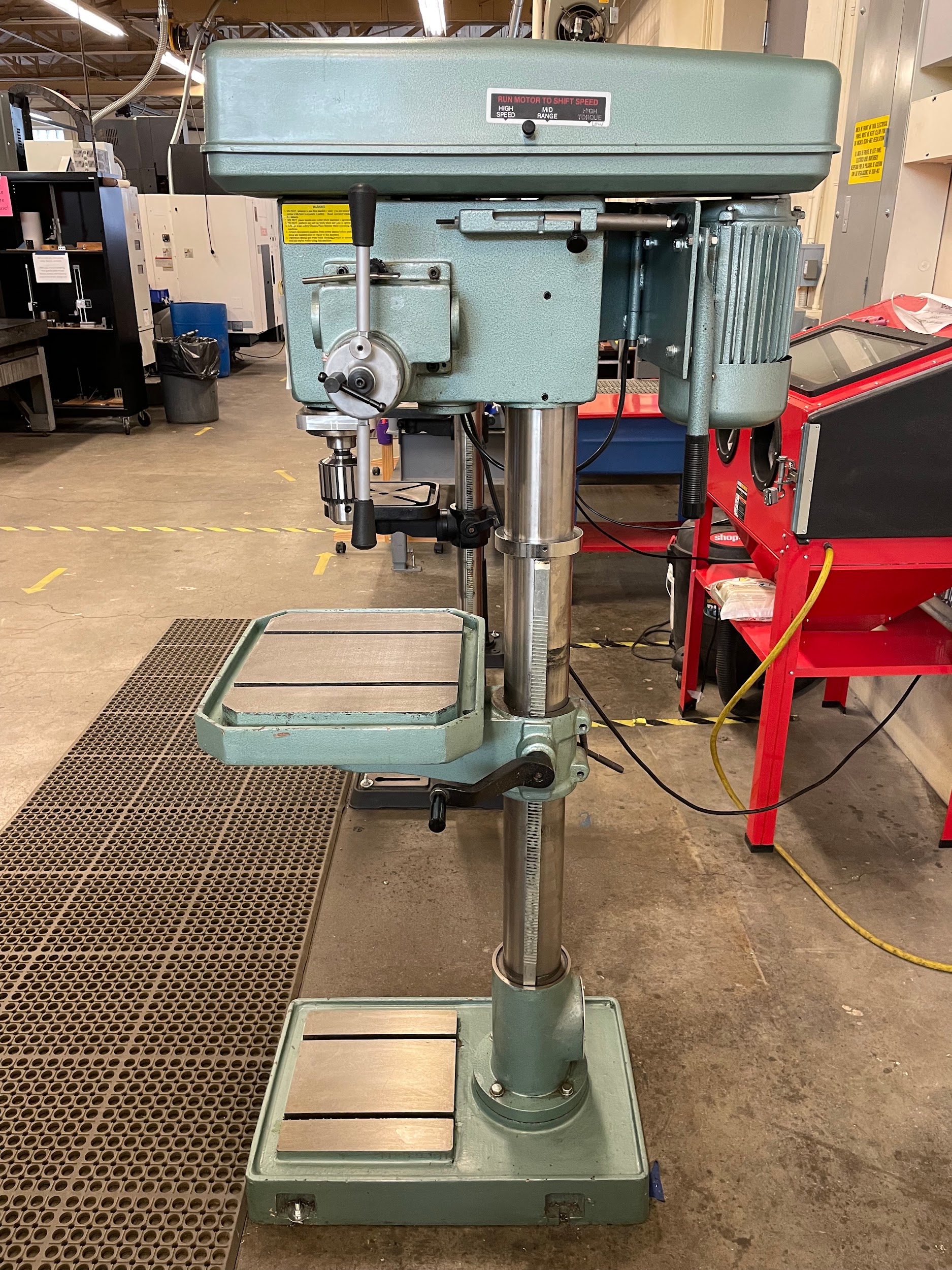 Full right side view of a variable speed drill press with power feed.