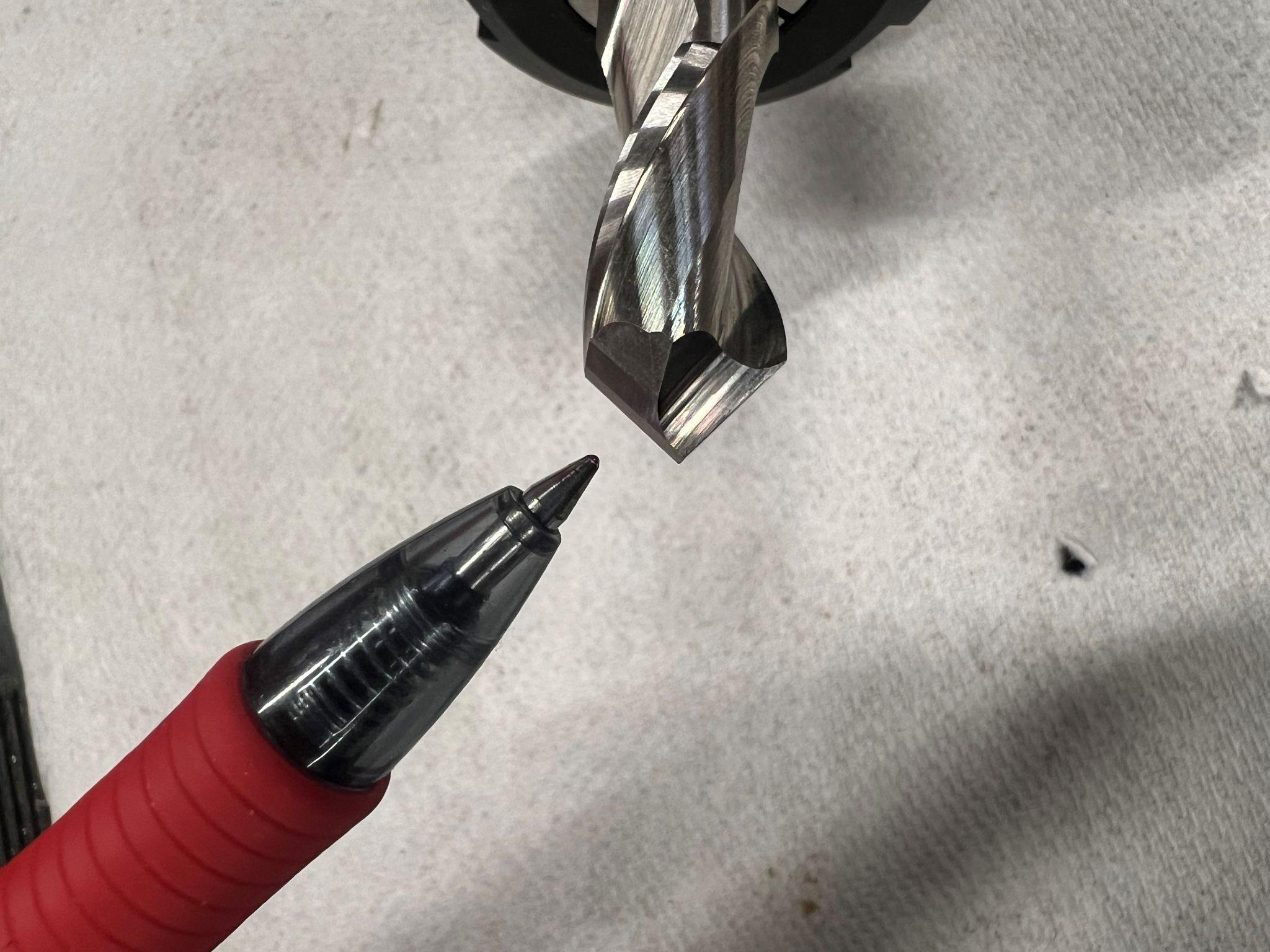 A close up view of a two flute end mill. This one is also a 90 degree chamfer mill due to the angle on the tip.