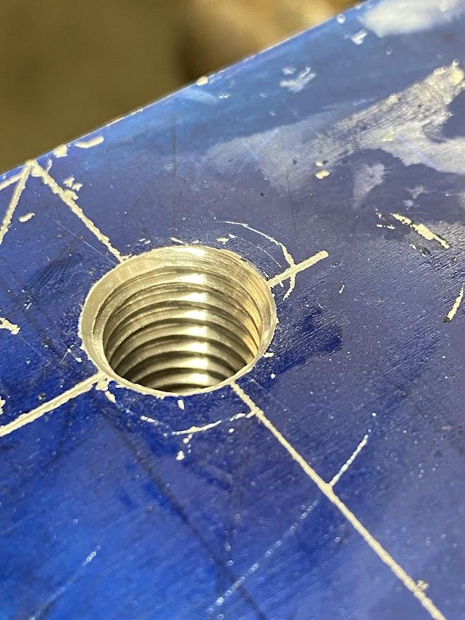 A satisfactory result of a tapped hole with a properly sized lead in chamfer and the formation of a full thread at the top of the hole.