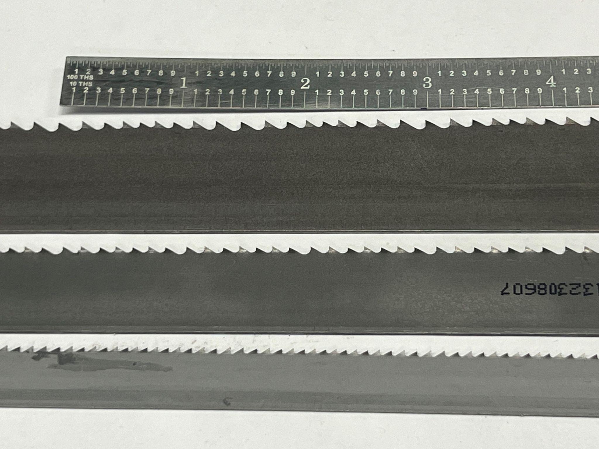 Saw blades and a steel rule positioned horizontally.