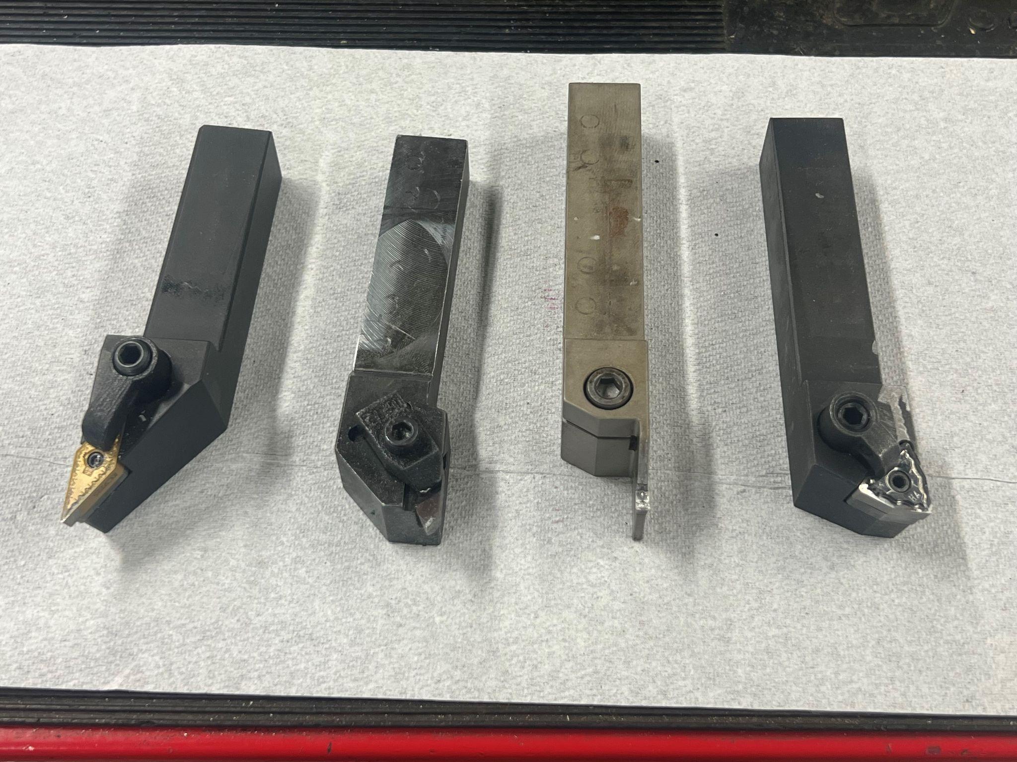 Four lathe tools; from left; left hand finish turn, threading tool, groove tool, and right hand turning tool.