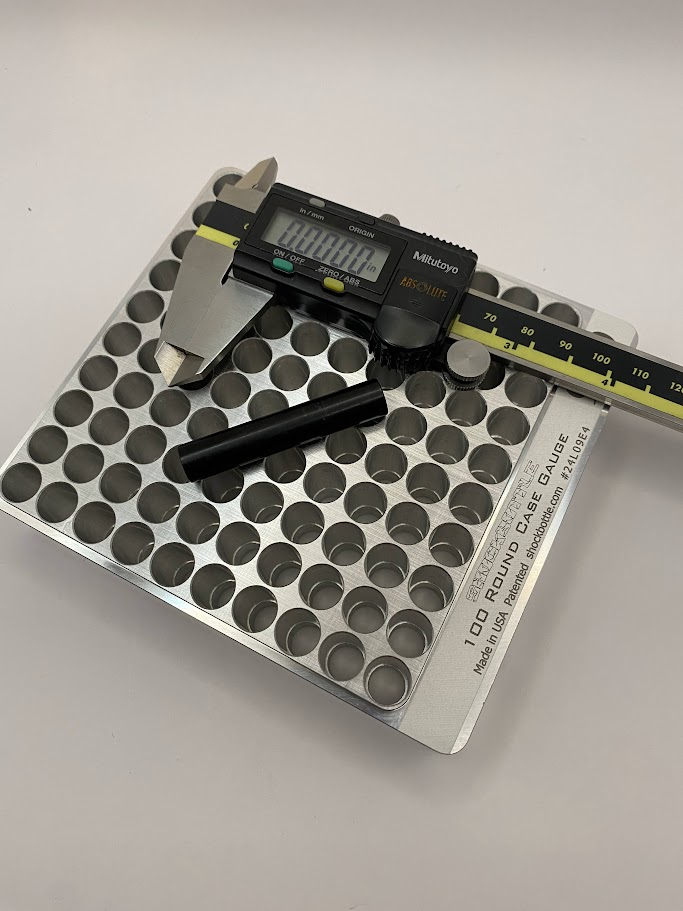 A picture of the part feature to be measured and a digital caliper and inspection pin.