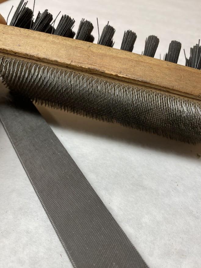 A file and a cleaning brush called a card file pictured together.