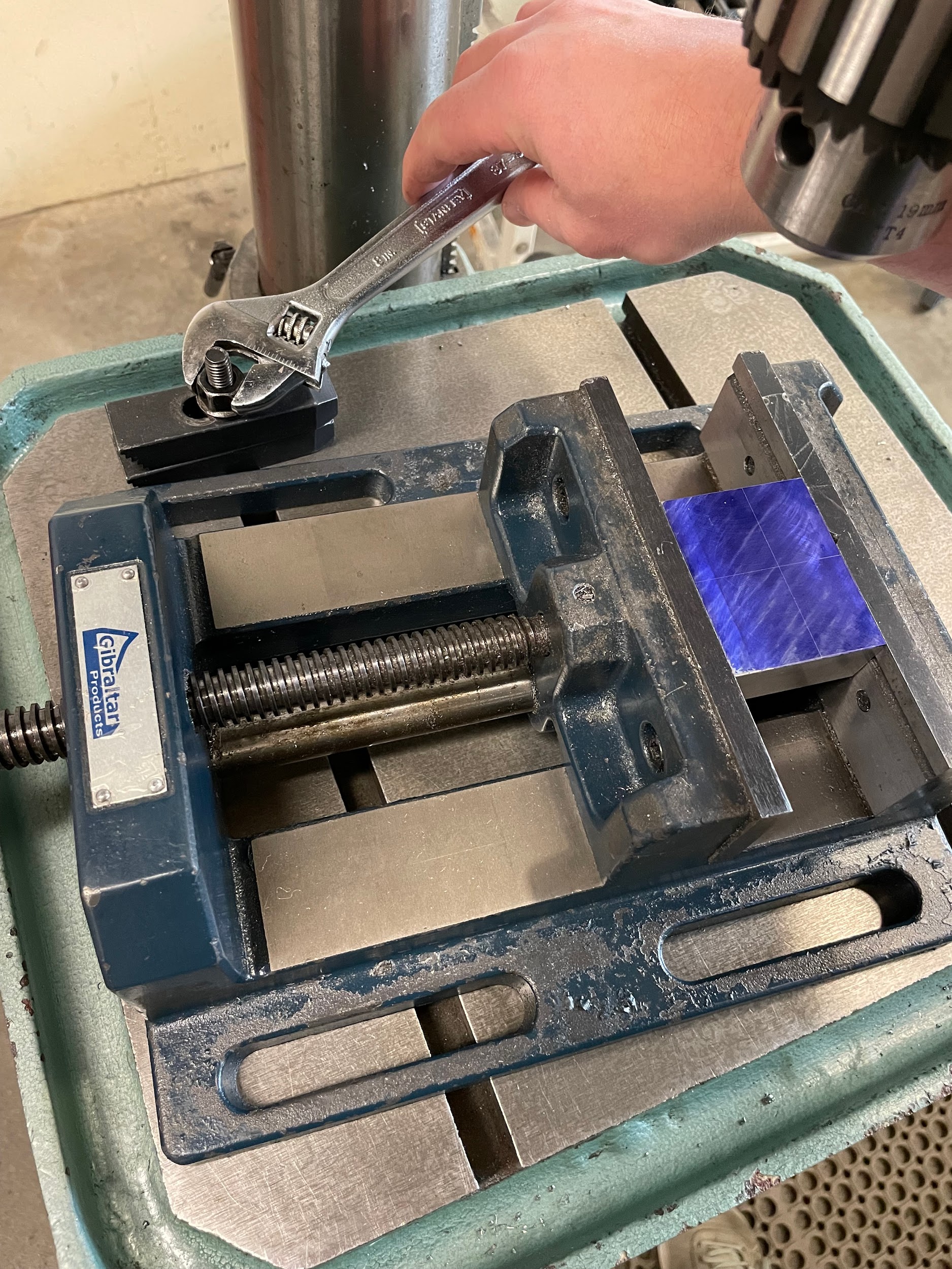 Installing a single fixture clamp to the table, tightened to itself, so it will act as a rotational stop for the vise.