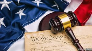 An image of the American flag, we the people document and a gavel