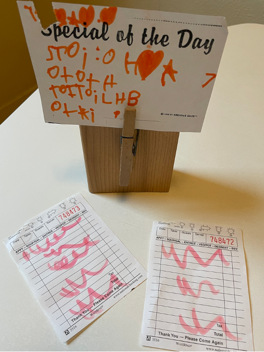 Pictures of children’s emergent writing with restaurant orders and special of the day.