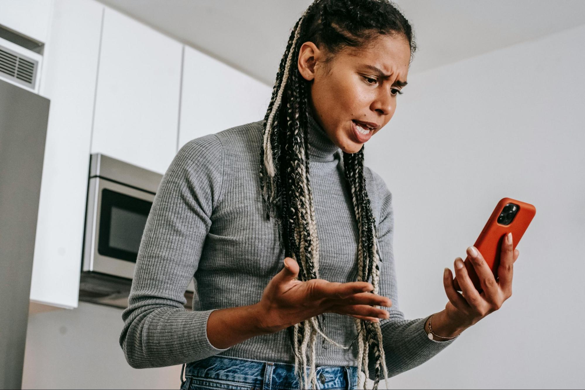 Woman on phone is annoyed. Photo portrays intent vs. impact (intent of the conversation had a different impact on the listener).