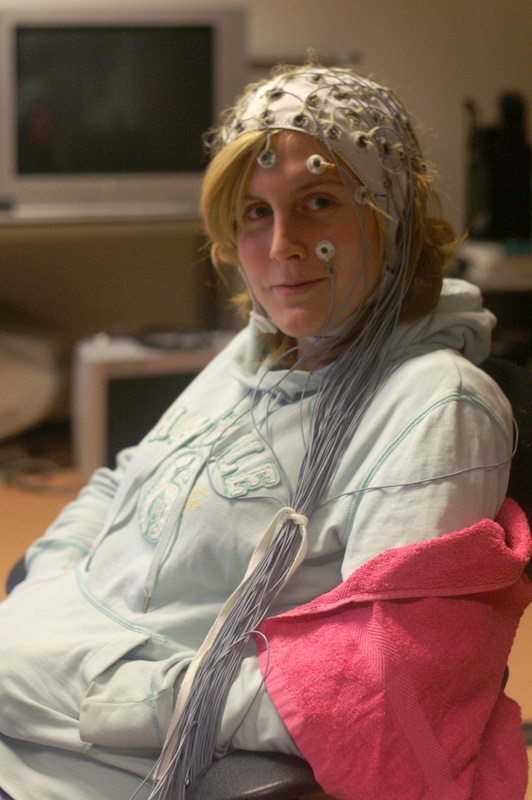 A woman wearing an EEG cap
