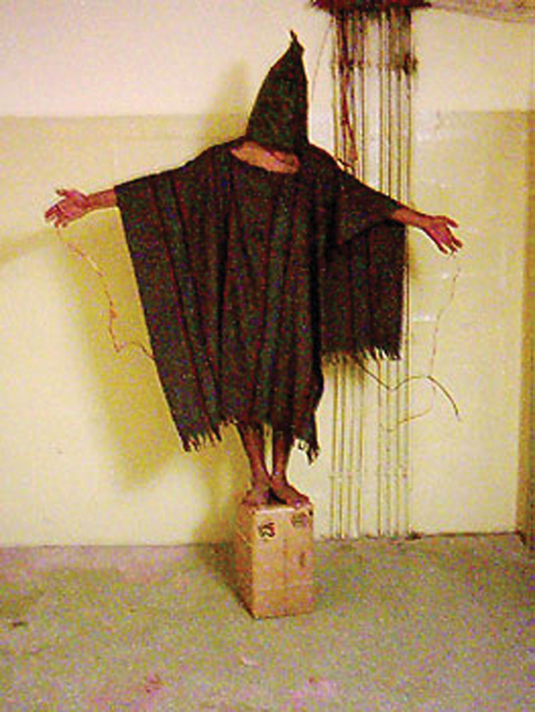 Photo of an Iraqi prisoner being tortured by soldiers at the Abu Gharib prison