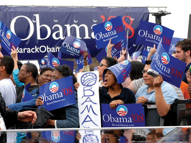 A crowd cheering for Barack Obama