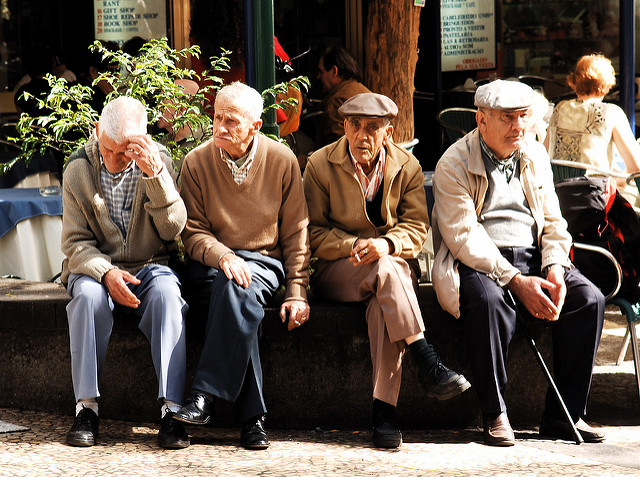 Four elderly men sitting on a bench