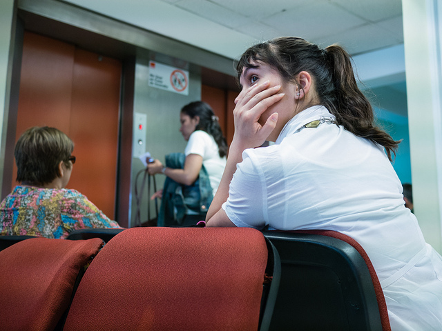 A woman in the waiting room at the hospital