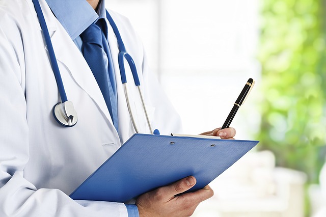 A doctor holding a clipboard and a pen