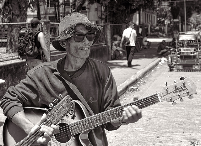 A street musician playing guitar