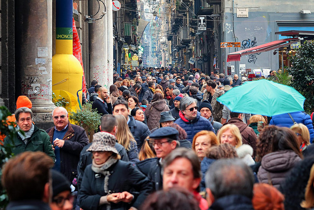 A crowd of people walking down a street