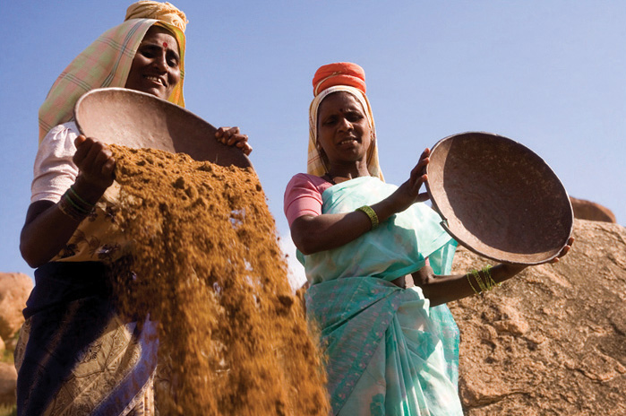 Women in India sifting through sand