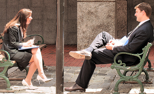 A conversation between two people on opposite benches