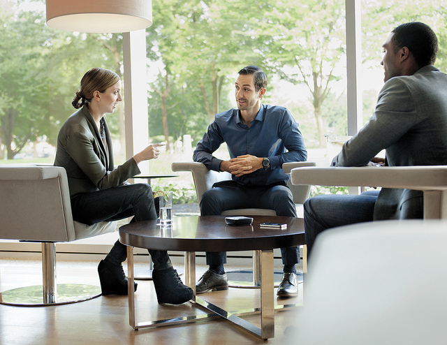 A small group or team working out some problems at a coffee table