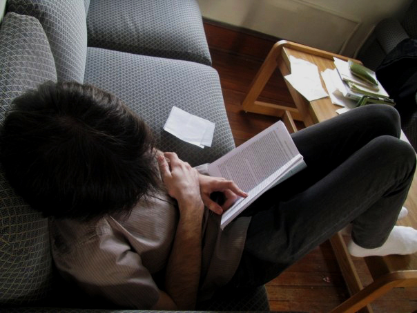 A student doing some late-night cramming on a couch