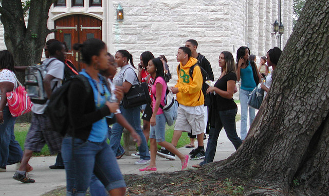 A candid shot of college students walking from class to class