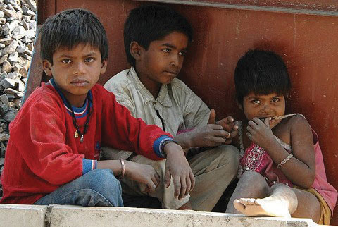 Three children from a poor nation, hanging out on the street