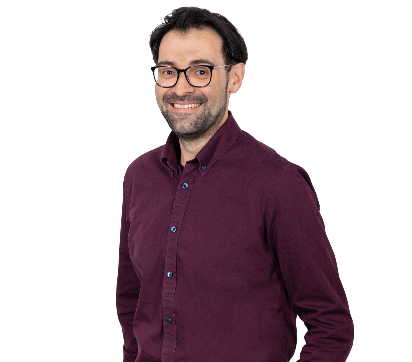 A photograph of a man with dark hair smiling directly at the camera. He is wearing a maroon colored shirt.