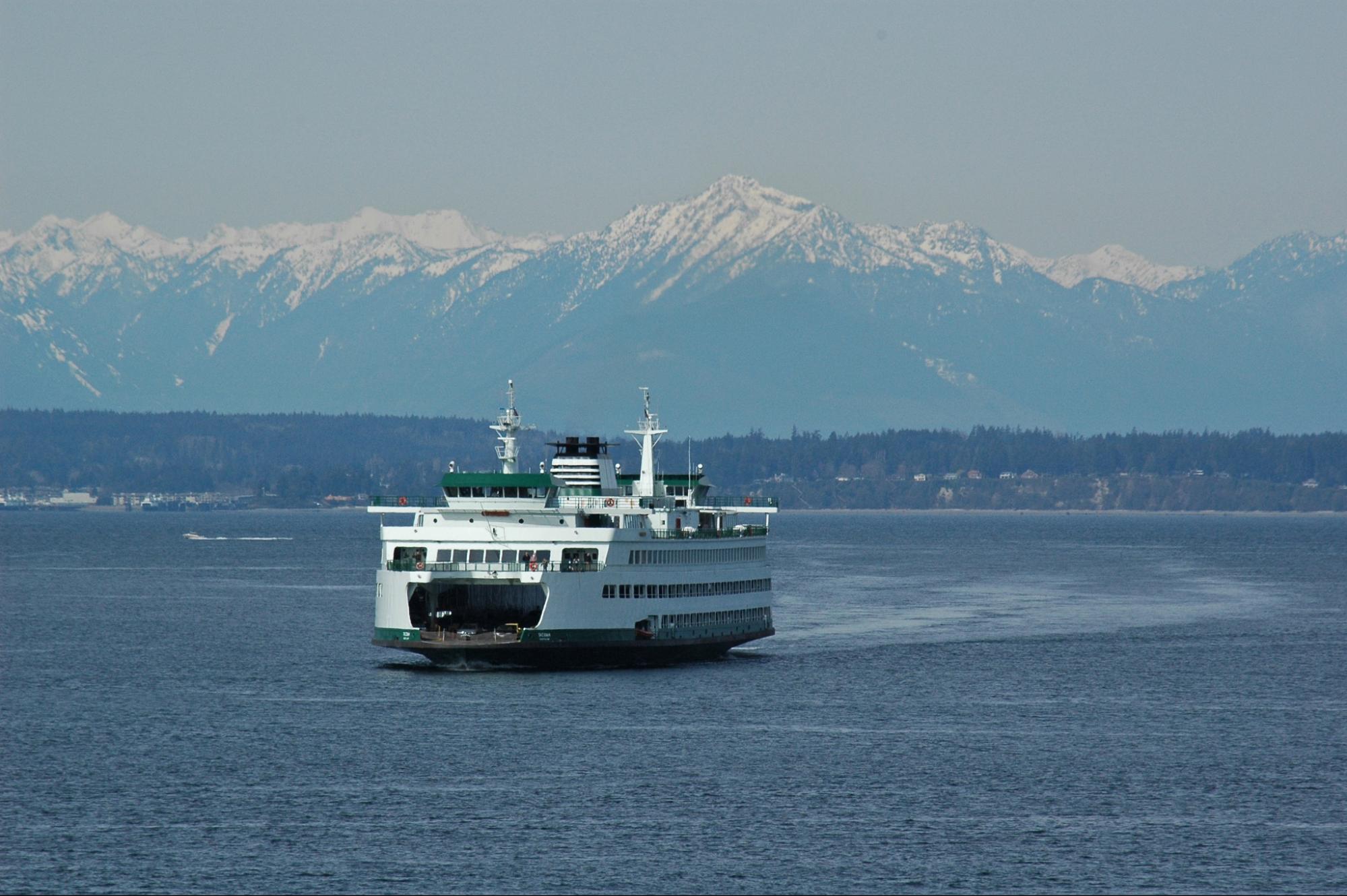 A ferry departing for Seattle against a backdrop of the Olympic Mountains in Washington State, U.S.