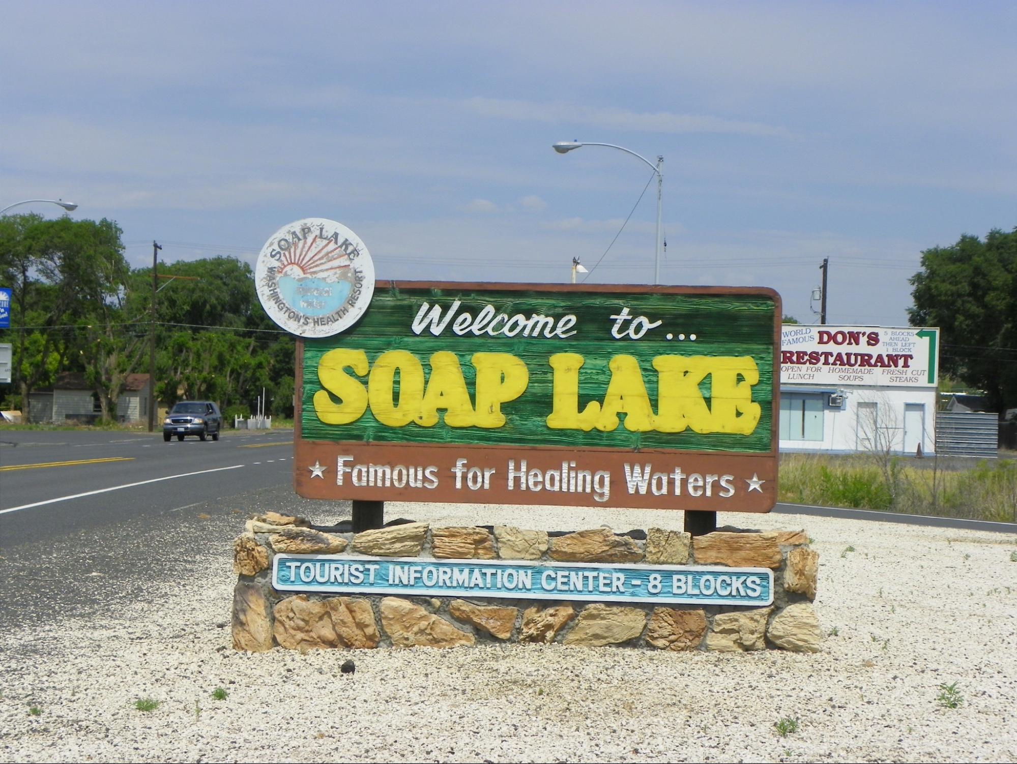 A large sign says “Welcome to Soap Lake Famous for Healing Waters.”