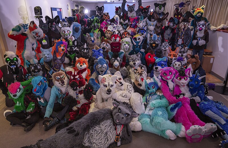 A group photo of a variety of fursuiters taken at Furry Black Light #7 in 2018