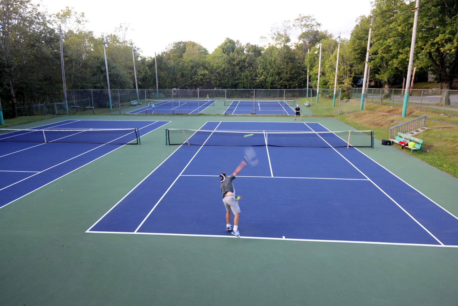 A friendly tennis match at a neighborhood club.