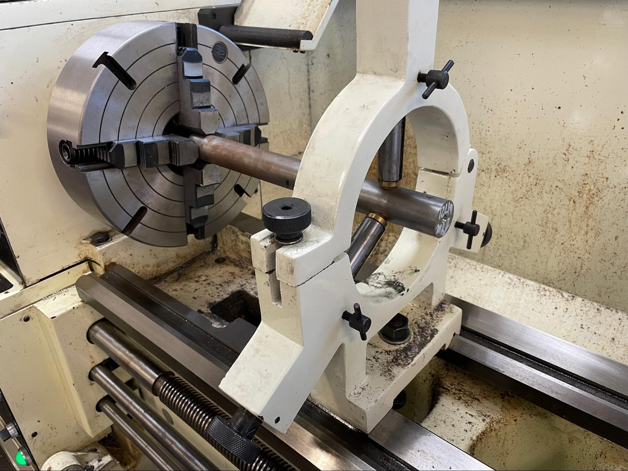 A steady rest in use supporting a long workpiece.