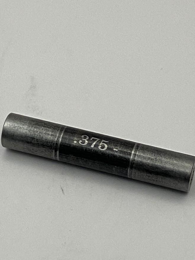 A black coated inspection pin with most of the black coating worn off the surface exposing the metal beneath.