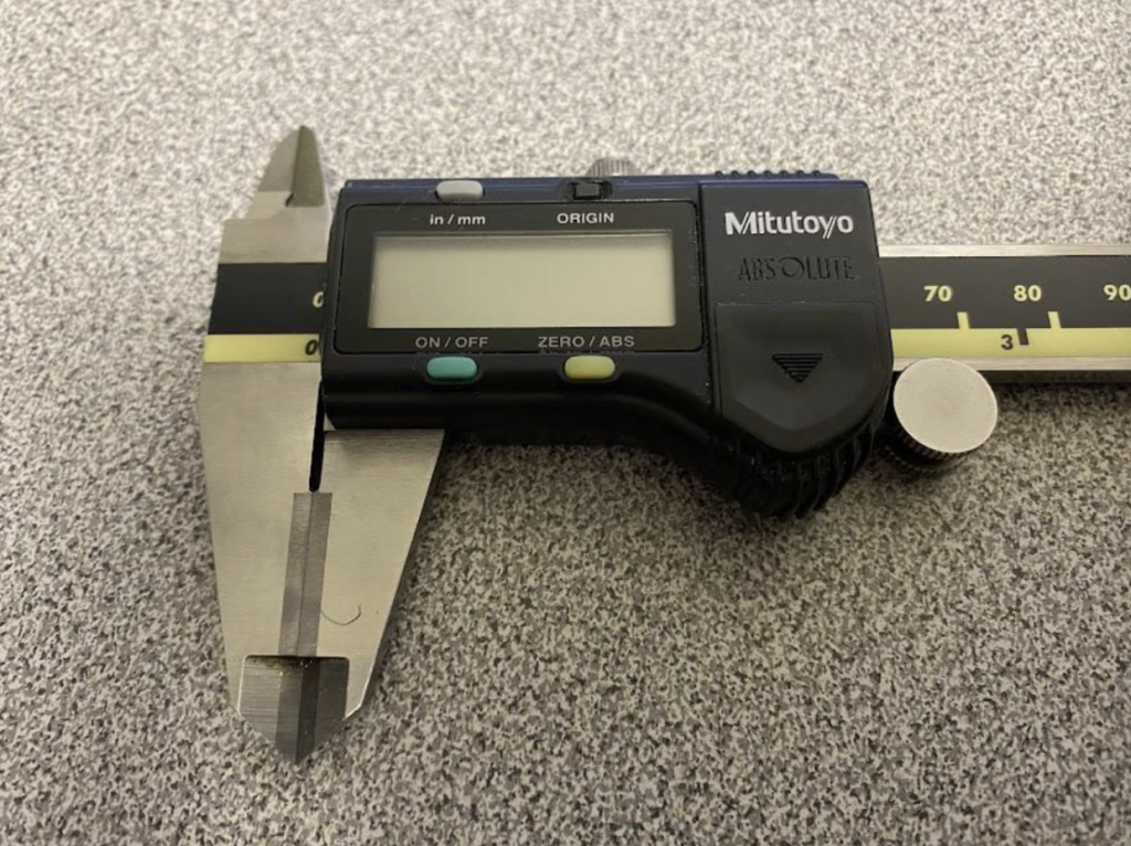 A slide caliper with carbide inserts on the outside measuring surfaces.