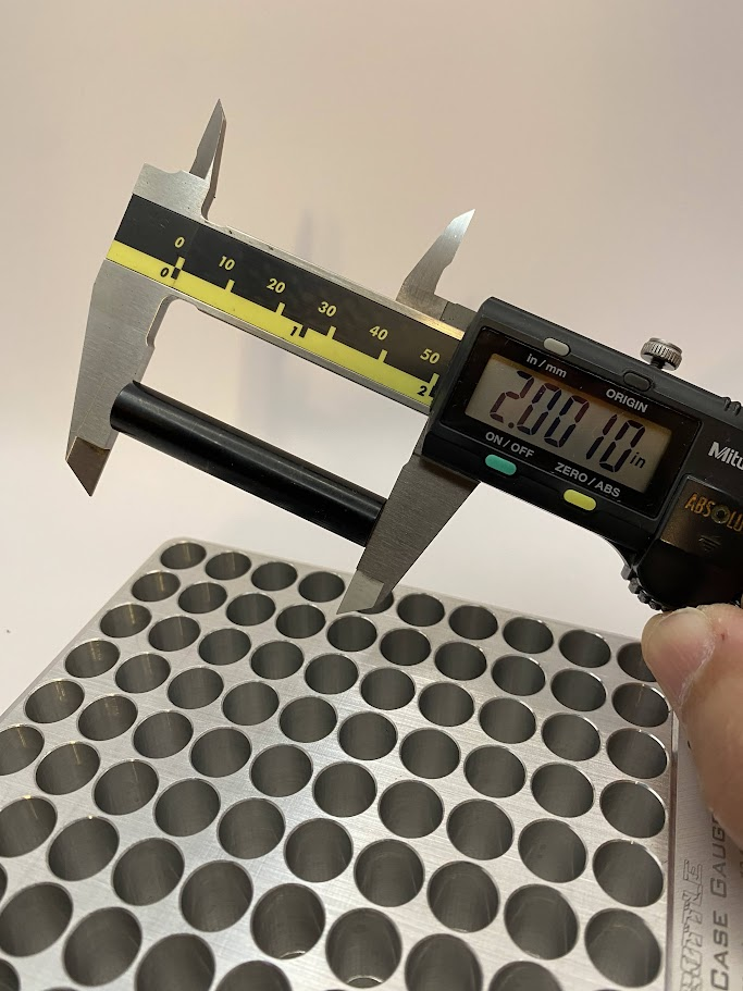 A digital caliper is placed over the length of an inspection pin and the OD jaws are closed.