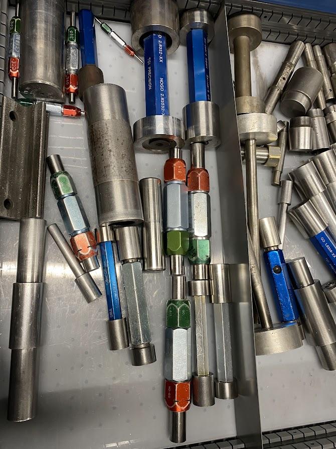 A drawer with an assortment of inspection pin Go/No-Go pins.