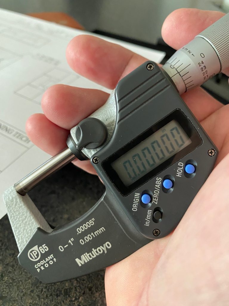 A zero to one inch micrometer is closed and the digital display indicates zero.