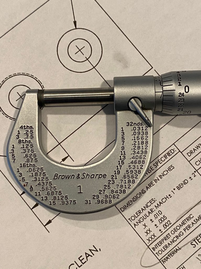A zero to one inch micrometer is closed and the vernier scale indicates zero.