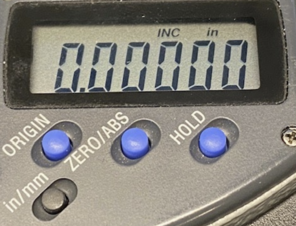 The digital display of a zero to one inch micrometer indicates zero and the “INC” indicator is illuminated.