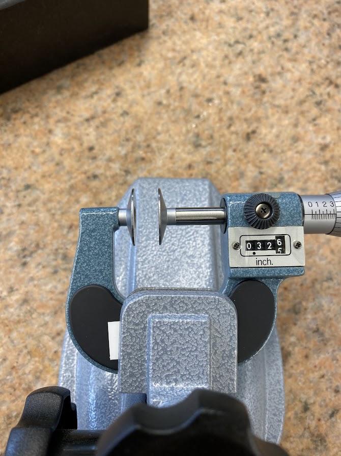 The disc micrometer is clamped in the mic stand to allow the operator more ease in using the micrometer.
