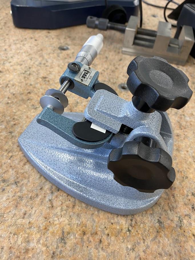 A disc micrometer is clamped in a mic stand.