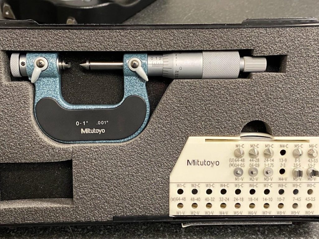 A thread micrometer set in a case with a mic body and a selection of thread anvils.