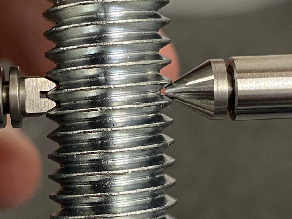 A thread mic is closed over the threads of a bolt.