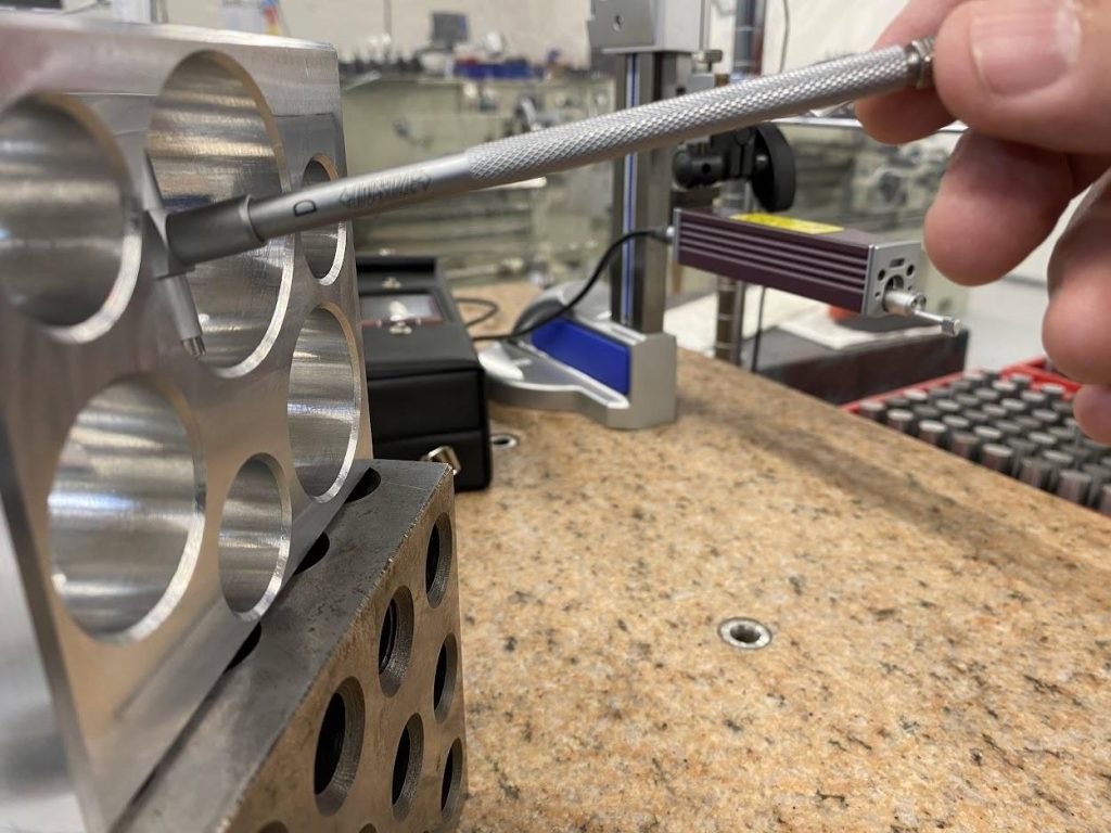 A snap gage in a bore with the handle sloped up.