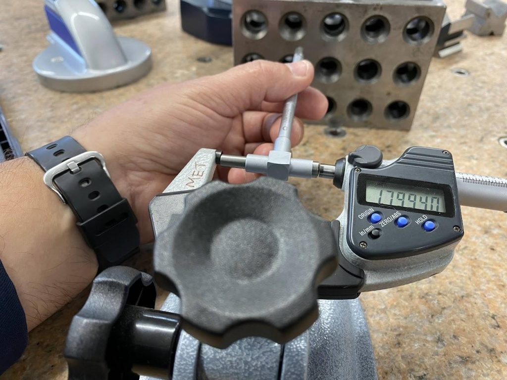 A snap gage between the anvil and spindle of an outside micrometer.