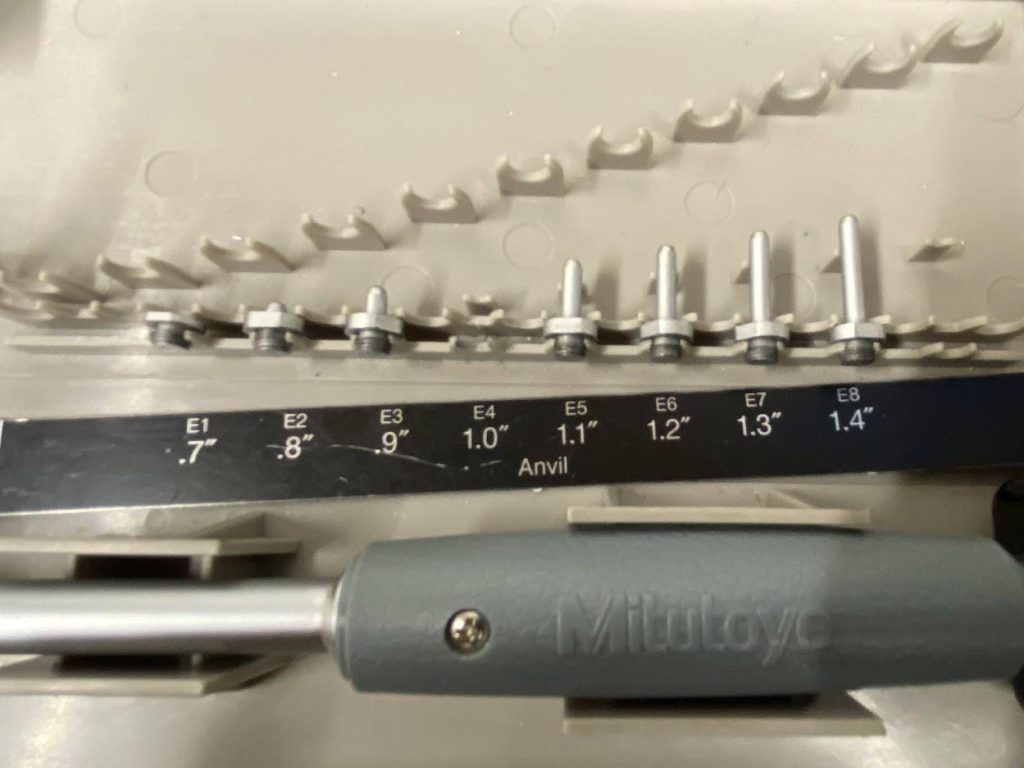 A set of anvils for a bore gage on a plastic case.