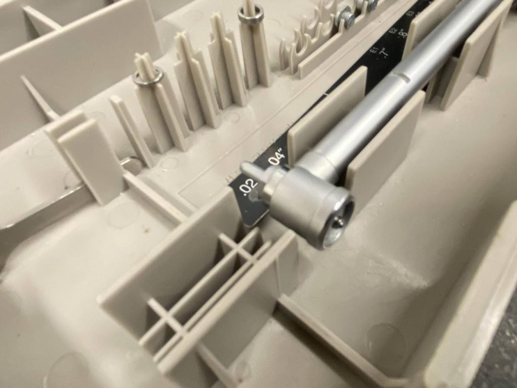 The end of a bore gage with an anvil installed.