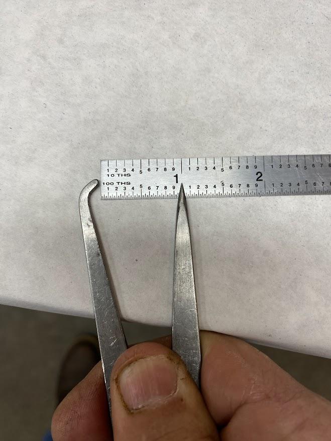 An odd leg caliper is placed against a ruler and set to one inch.