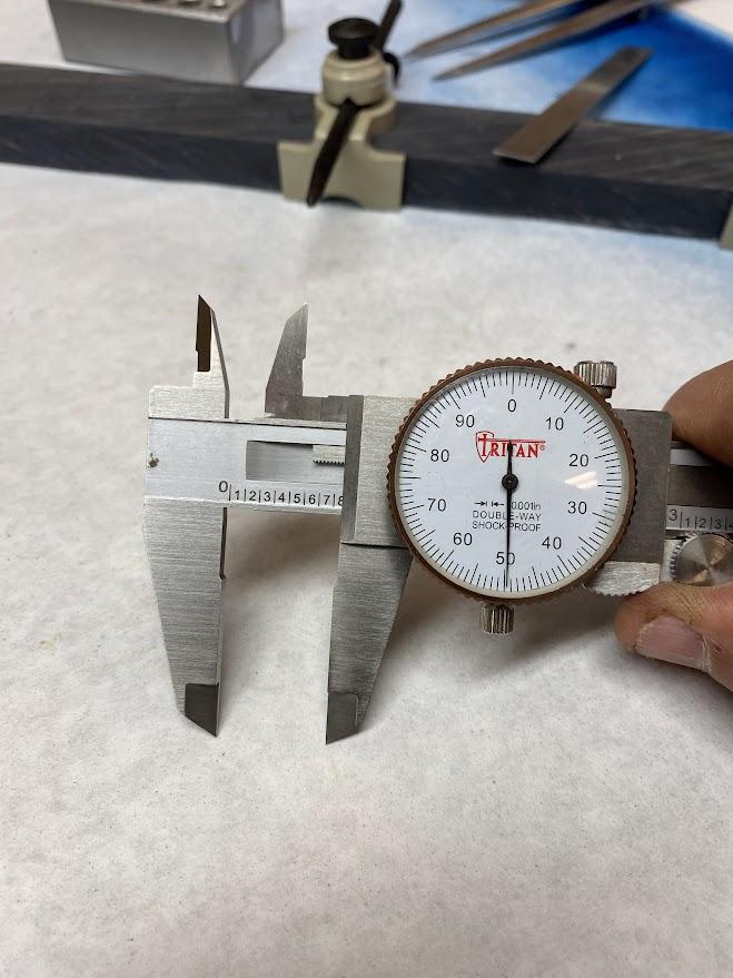 A slide caliper set to ¾”.